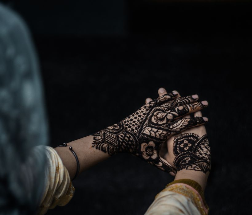 Detailed henna design photographed against a dark background
