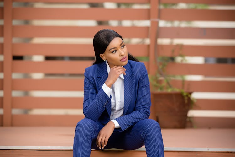 Woman In Blue Suit Looking Away