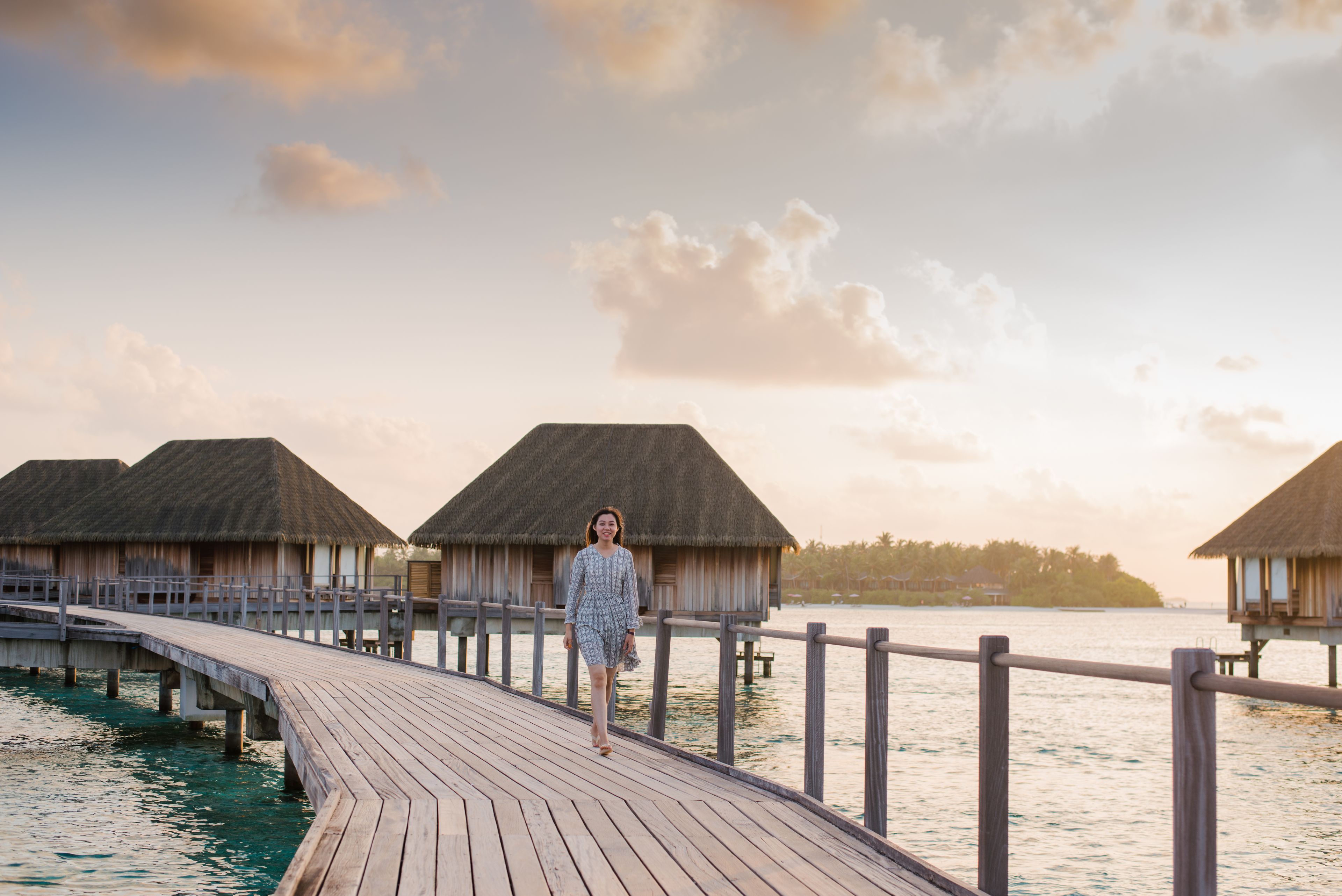 Overwater honeymoon villa at sunset in North Male Atoll, Maldives