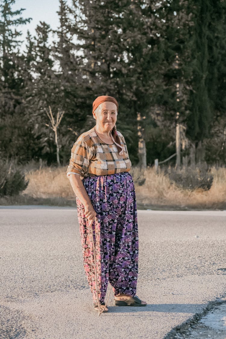 Elderly Woman Standing With Stick Cane