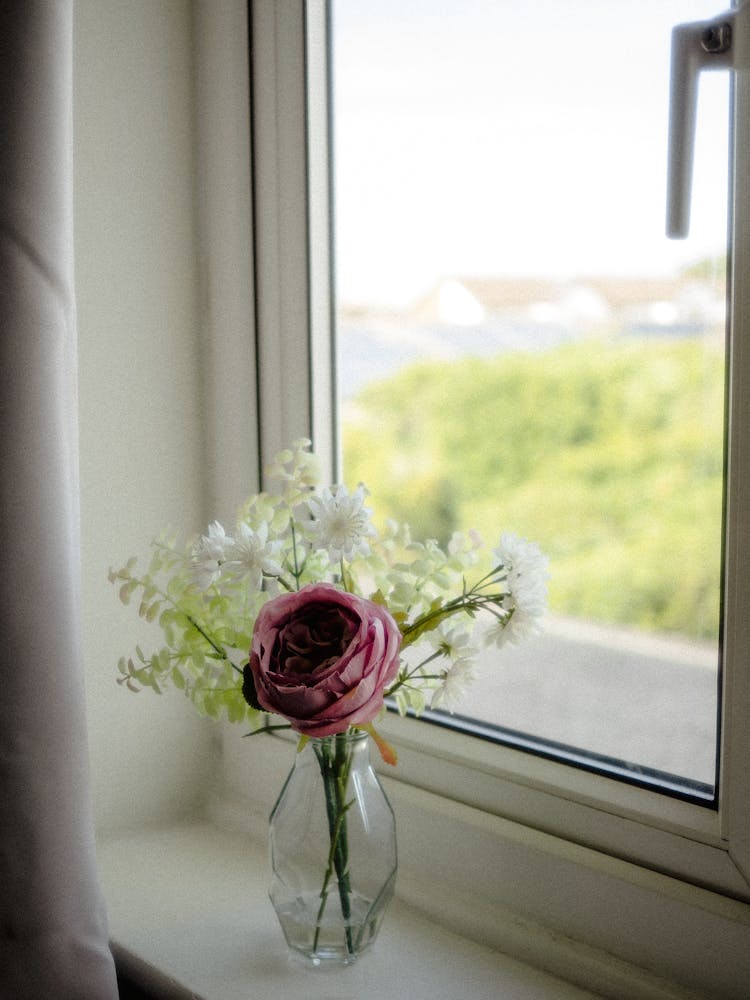 Vase With Flowers On A Windowsill