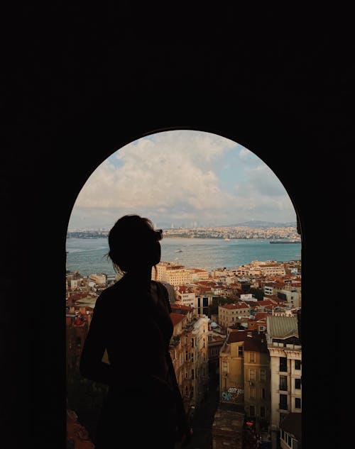 Silhouette of Woman at Galata Tower with Istanbul Buildings behind