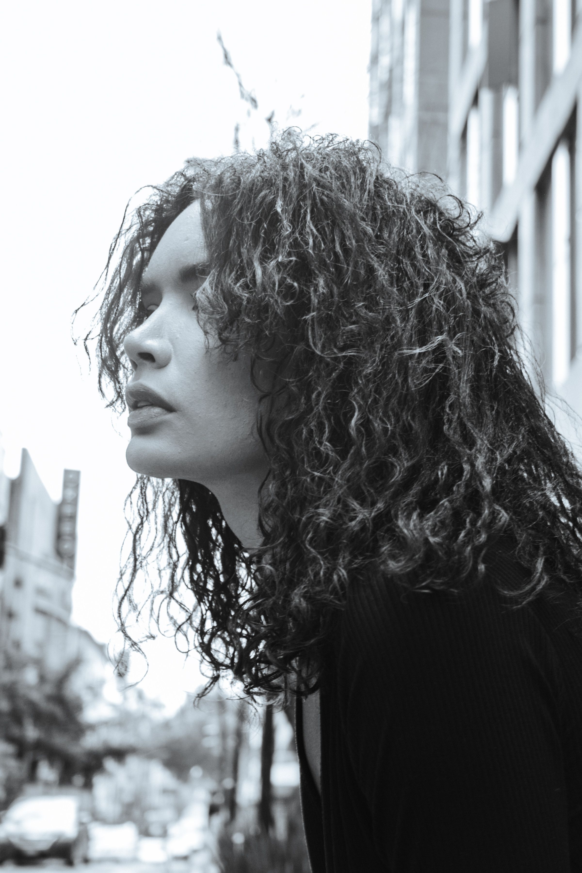 Young Woman with Curly Hair Covering Her Face · Free Stock Photo