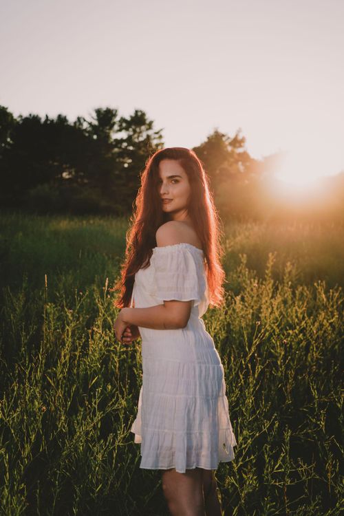 A Woman in White Dress Standing on Green Grass Field · Free Stock Photo