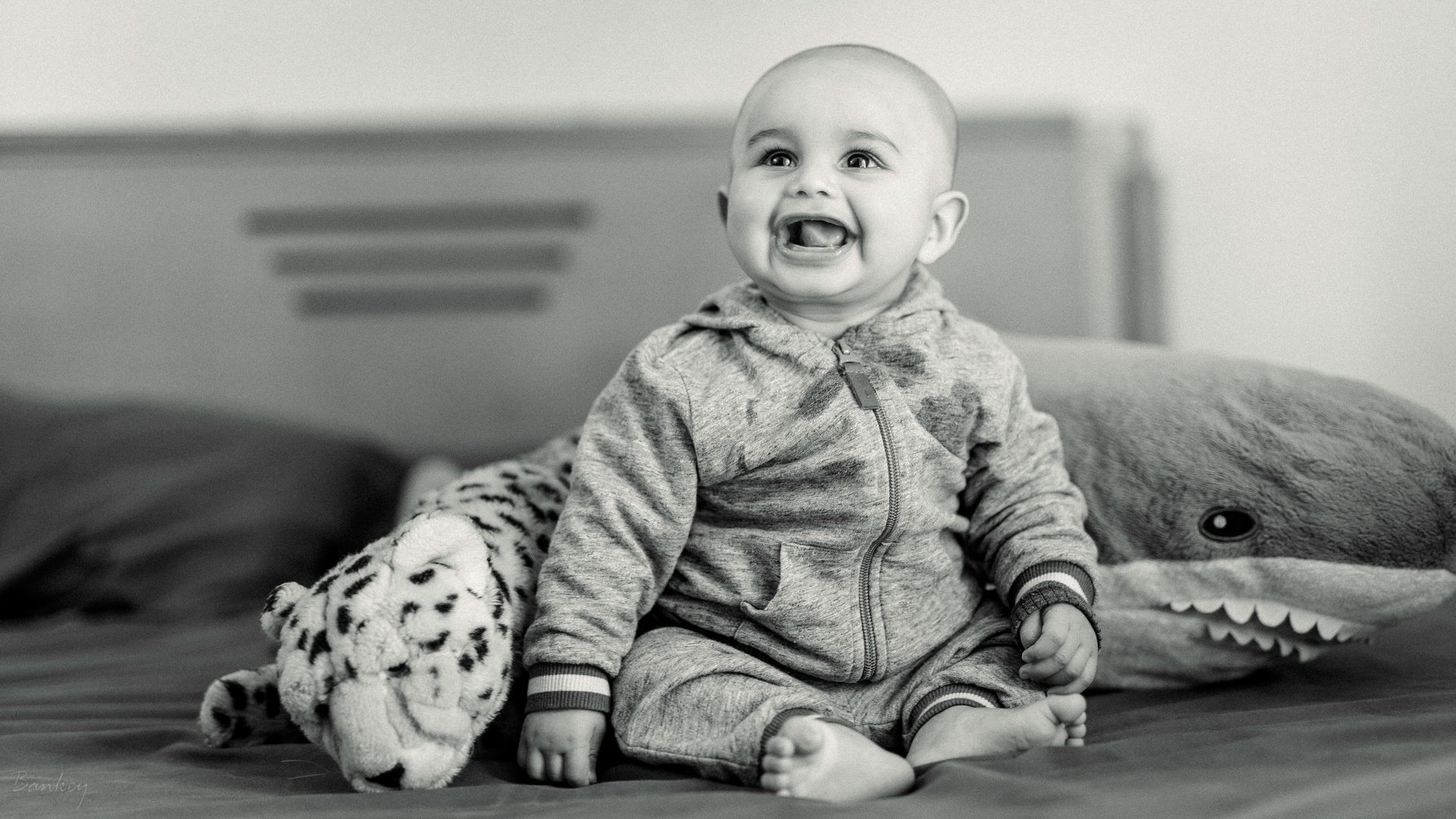 Grayscale Photo of a Baby Boy While Smiling