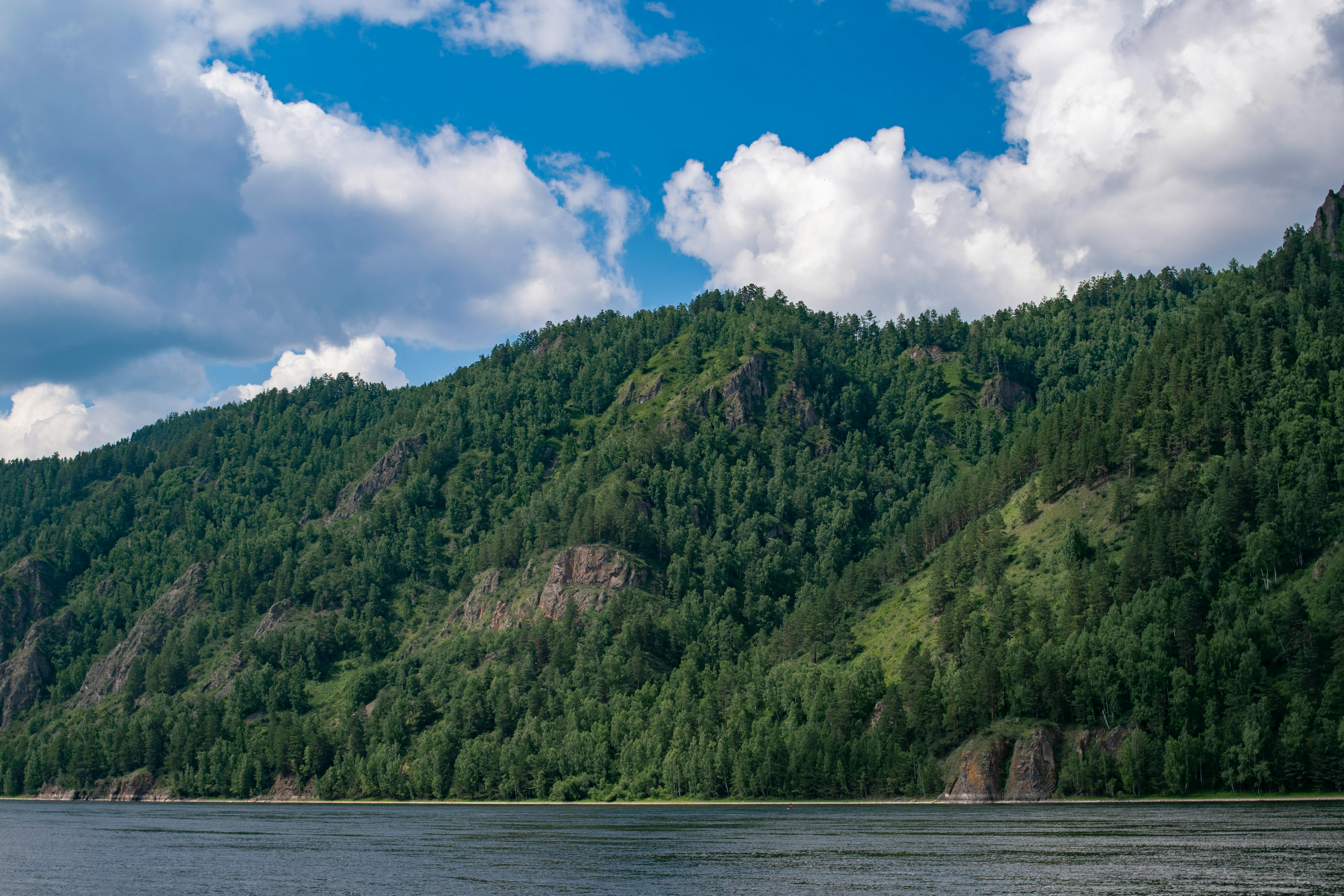 Body of Water in a Valley Surrounded by Mountains · Free Stock Photo