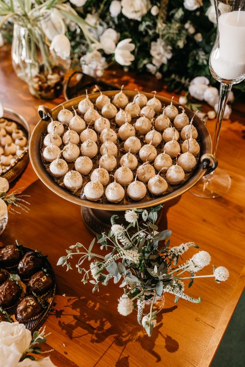 Free Elevated view of a decorative dessert table with elegant floral arrangements. Stock Photo