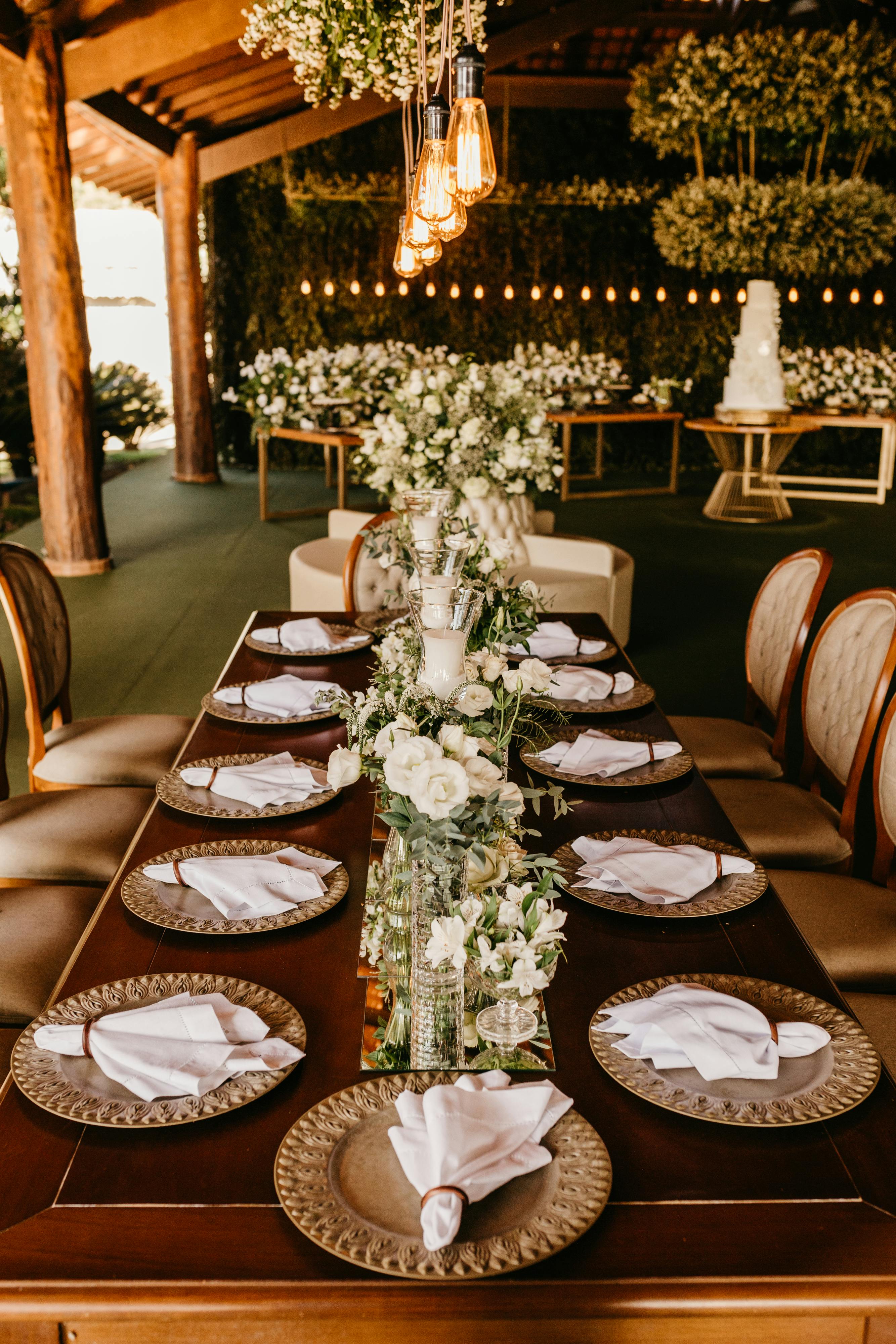 Beautifully decorated wedding table with elegant floral arrangements and warm lighting.