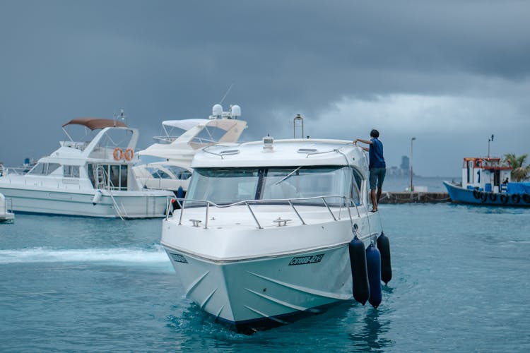 White And Blue Boat On Sea