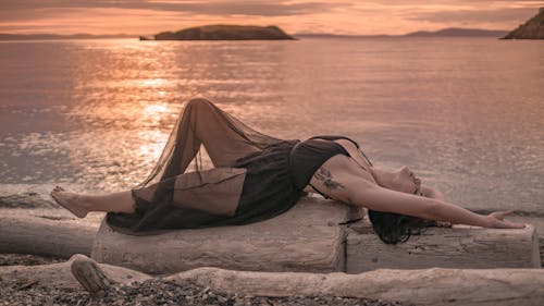 Woman Lying on a Wood Log