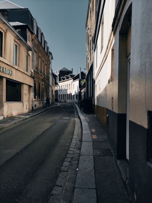 An Empty Road Between Buildings