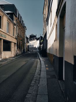Explore a quaint street lined with historic buildings showcasing elegant facades and a serene atmosphere.