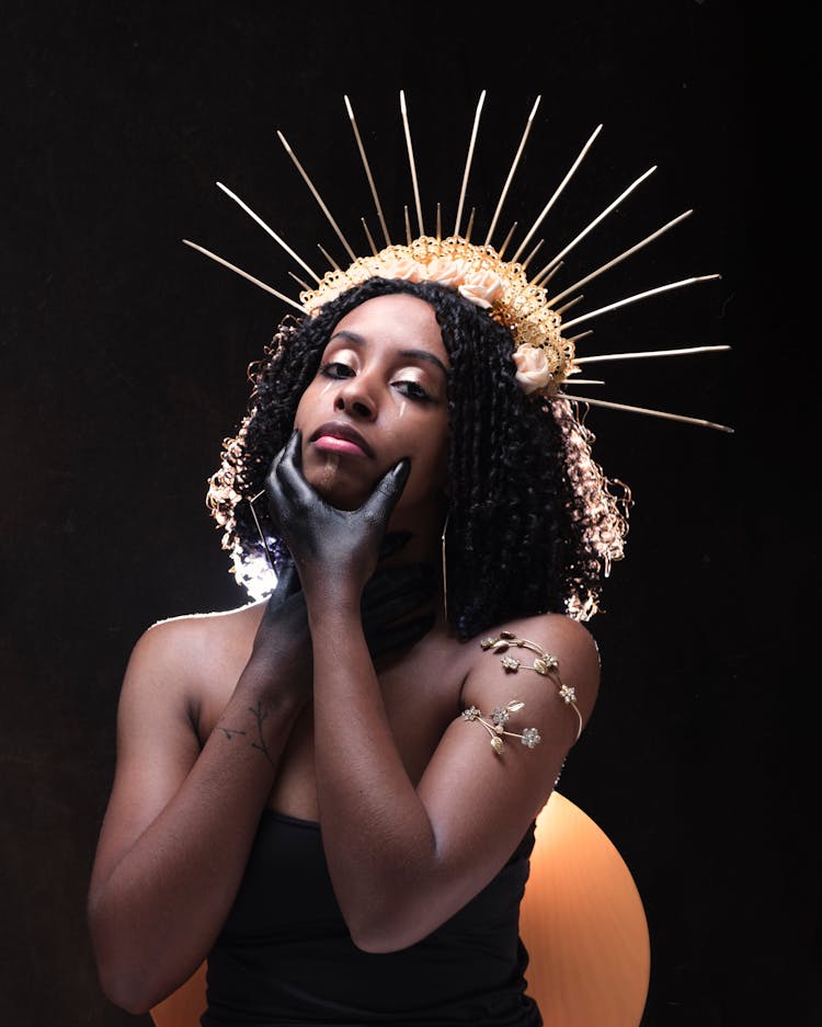 Portrait Of Woman In Crown On Black Studio Background