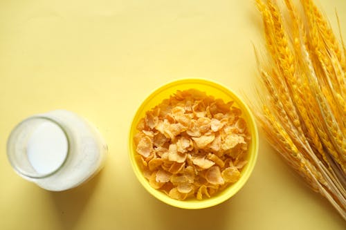 Free Corn Flakes on Yellow Plastic Bowl  Stock Photo