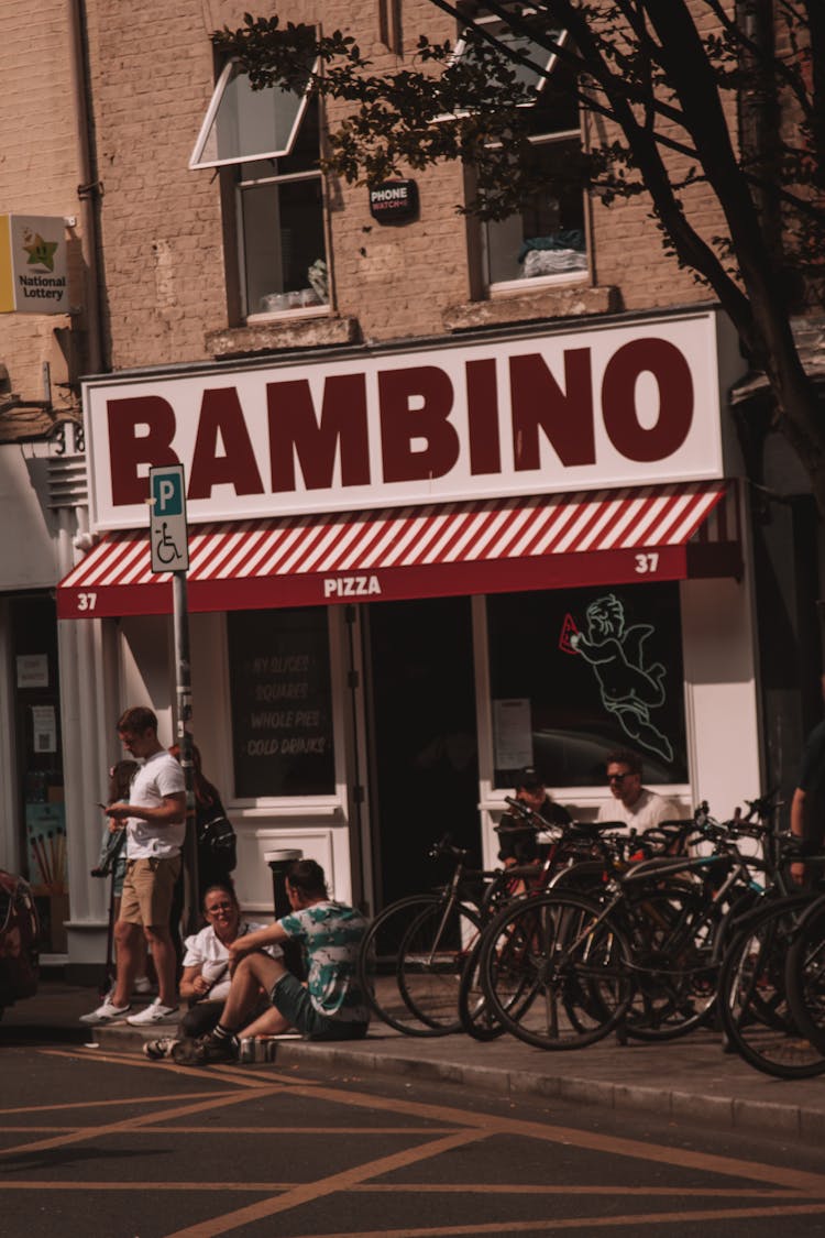 People In Front Of A Pizzeria 