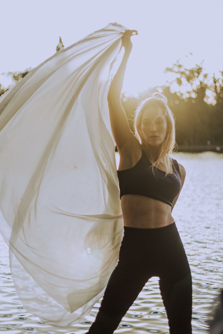 Athletic Woman Holding Up White Veil