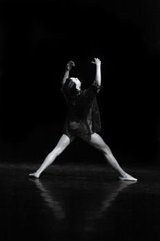 A monochrome image of a dancer showcasing flexibility and grace in a powerful pose.