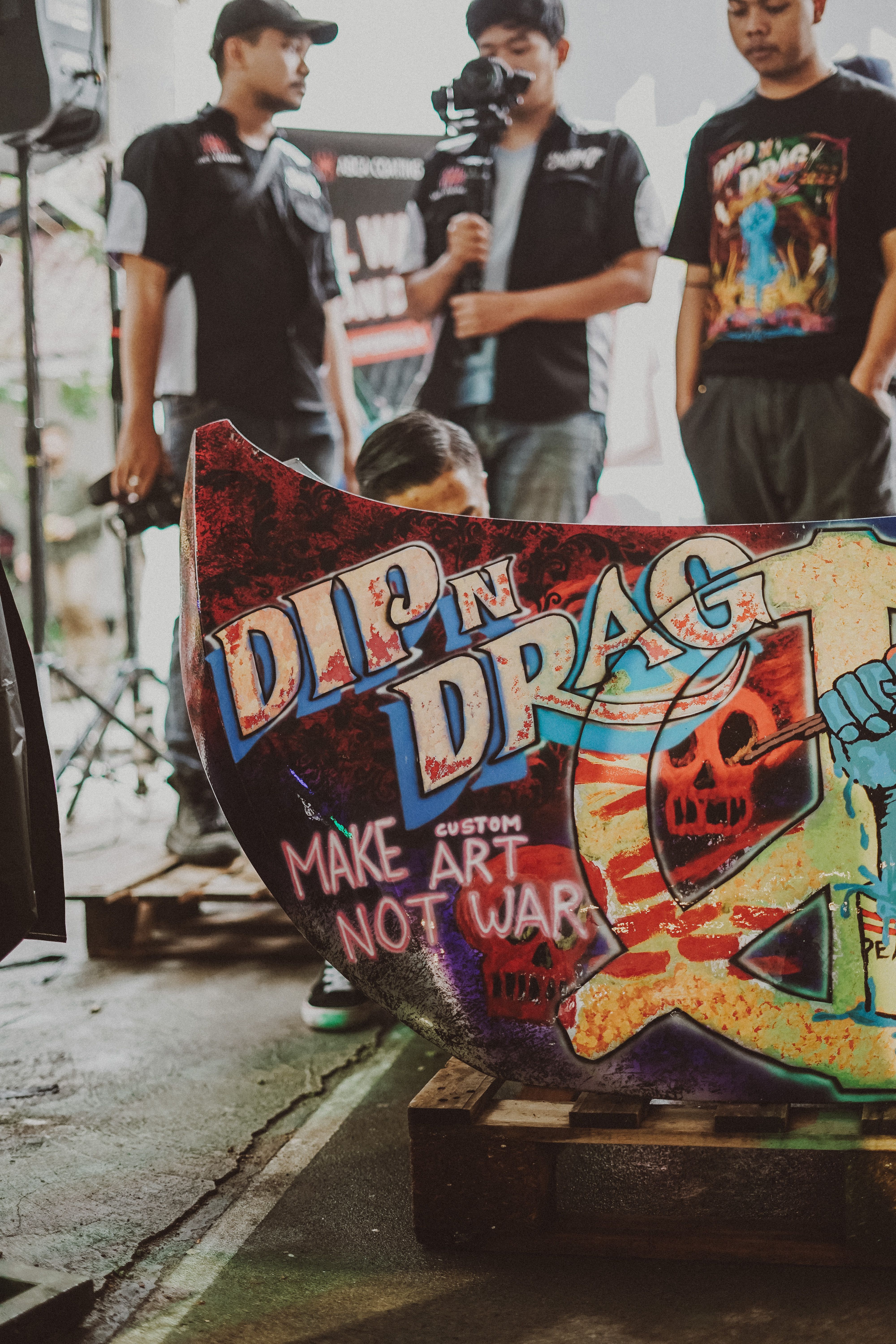 Colorful graffiti art with people at a lively urban art event. Creative street vibes.