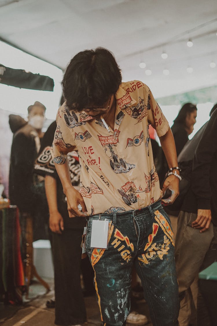 Crowd In A Tent And A Man Wearing Patterned Clothes