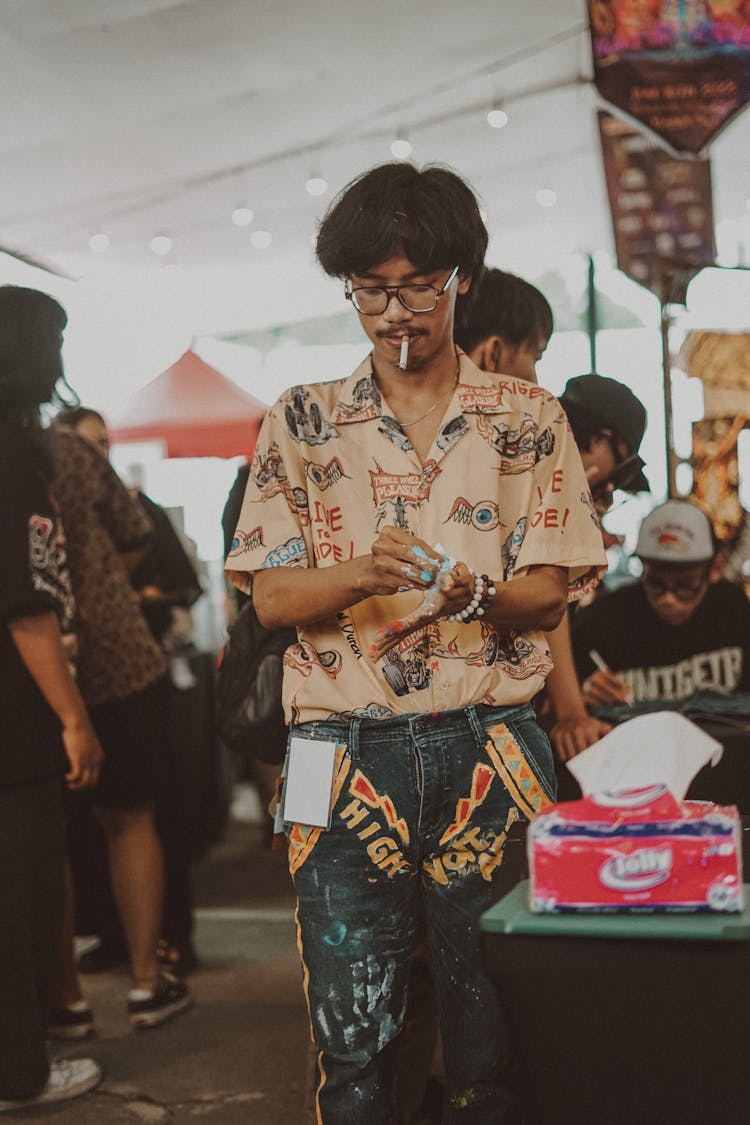 Man Wiping Hands With Tissue Paper