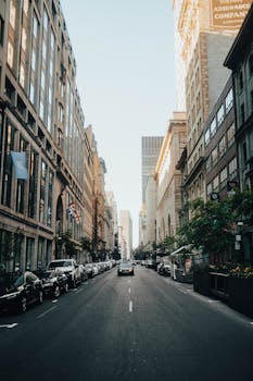 Explore the dynamic city life with historic buildings lining a bustling Montreal street on a bright day.