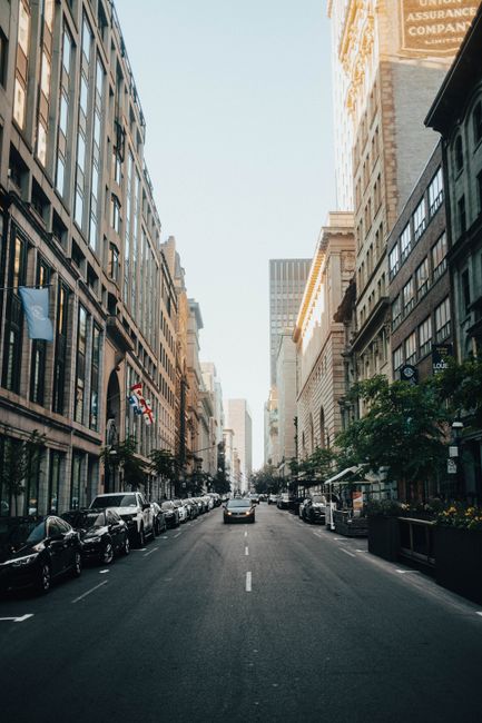 Explore the dynamic city life with historic buildings lining a bustling Montreal street on a bright day.
