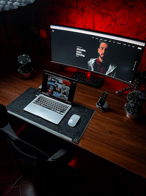 Laptop and Computer Monitor on Wooden Table