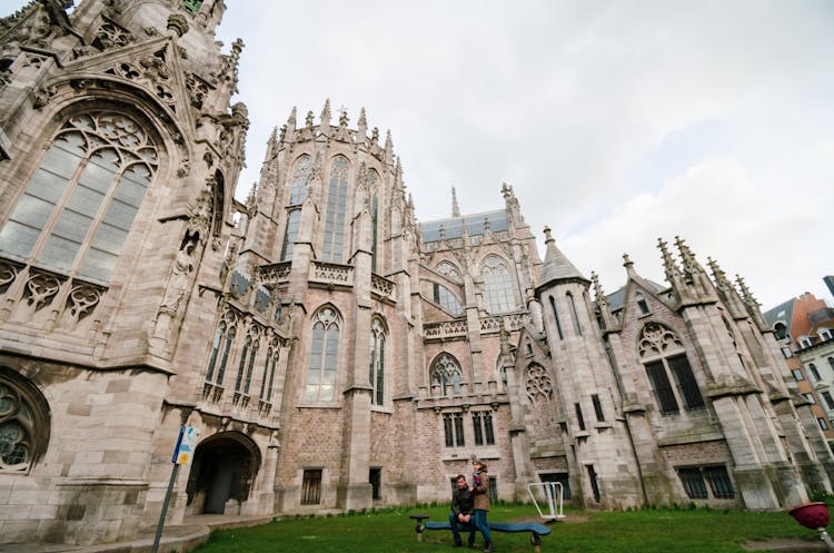 Two Tourists Sitting Near The Cathedral