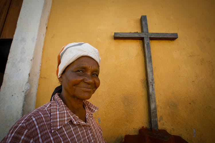 Smiling Woman And Wooden Cross Behind