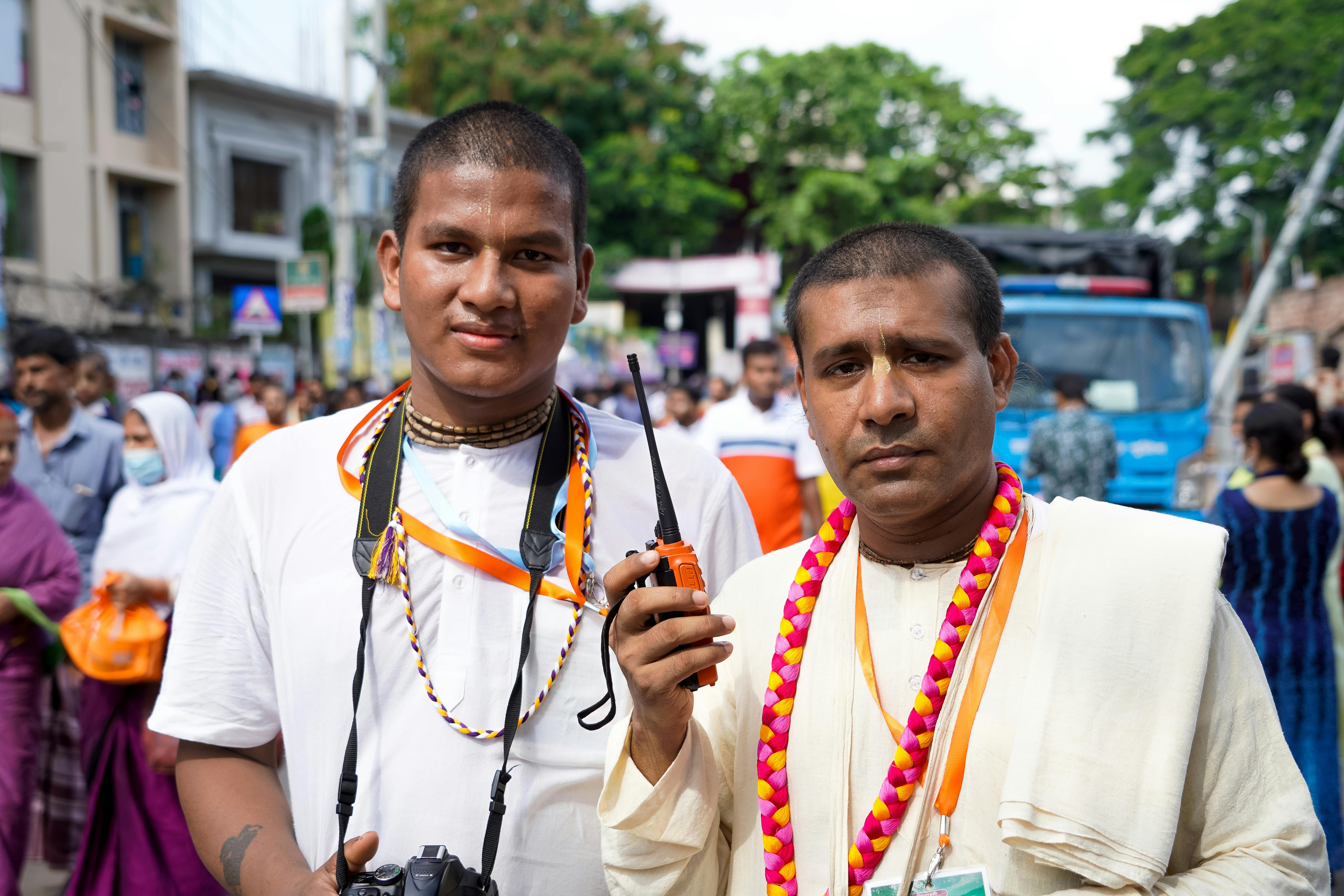 Two South Asian men in traditional attire at a cultural event in Dhaka, Bangladesh.