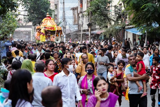 Crowded street festival procession in Dhaka city showcasing vibrant cultural celebration and community spirit.