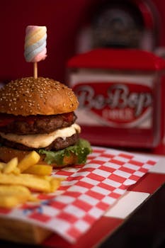 Mouthwatering cheeseburger and fries in a vintage diner setting, perfect for food photography enthusiasts.