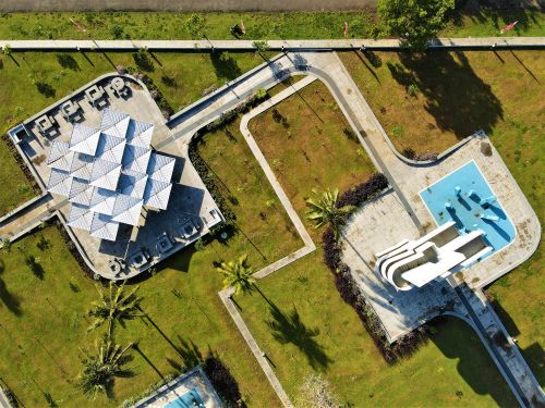 Free Aerial view of a modern park design with geometric structures and palm trees in Pangandaran, Indonesia. Stock Photo