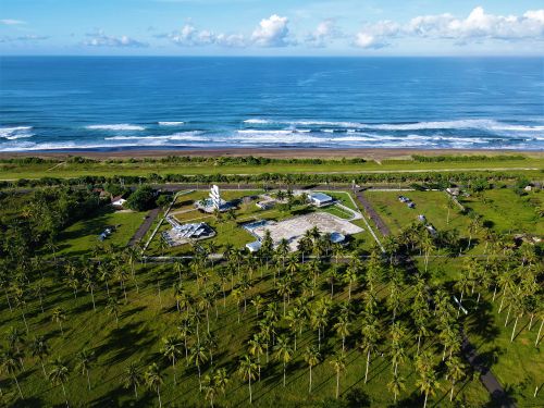 Free Stunning aerial shot of Pangandaran Beach, West Java, Indonesia, with palm trees and ocean waves. Stock Photo