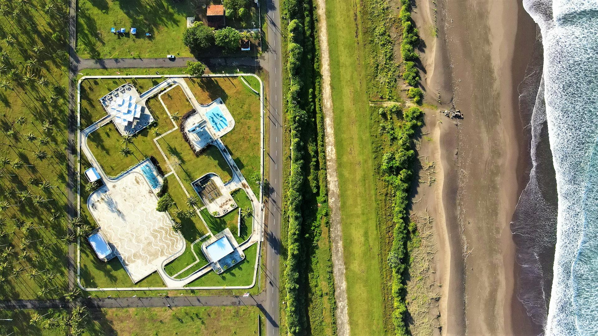 Aerial view of a seaside resort in Pangandaran, Indonesia showcasing a unique design and stunning beach.