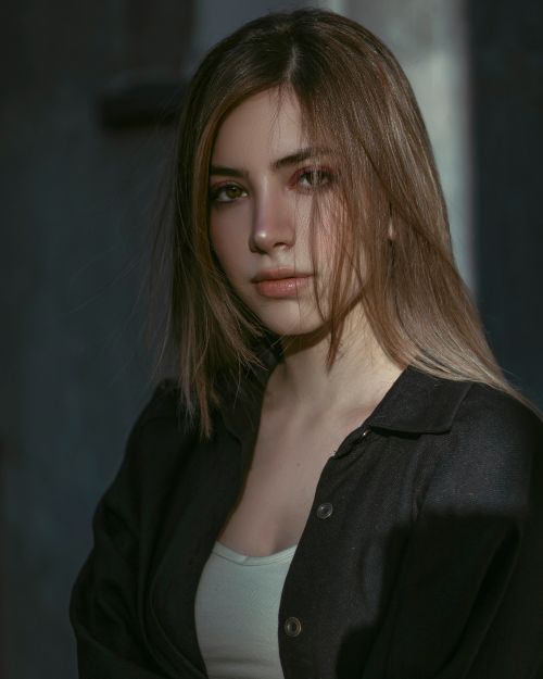 Free Close-up portrait of woman with long hair and black top, showcasing a calm expression. Stock Photo