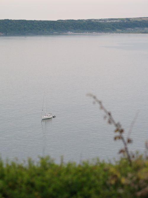 Free A lone sailboat floats peacefully on tranquil waters near Southgate, UK. Stock Photo