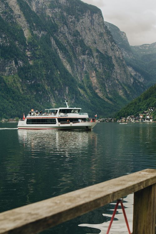 Free Scenic view of a ferry on Lake Hallstatt with the stunning alpine mountains in the background. Stock Photo