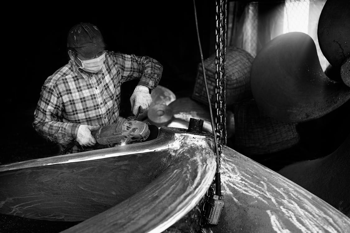 Man Grinding in a Workshop 