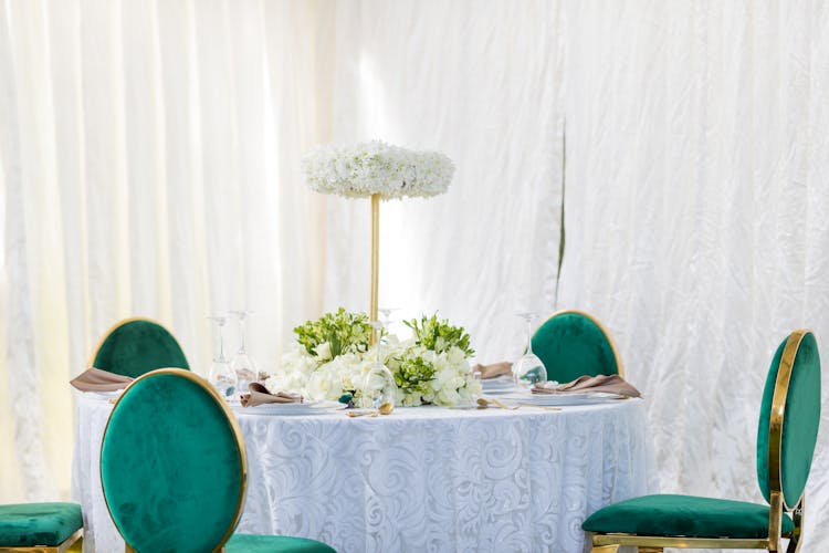 White Curtain Near Table With Flowers