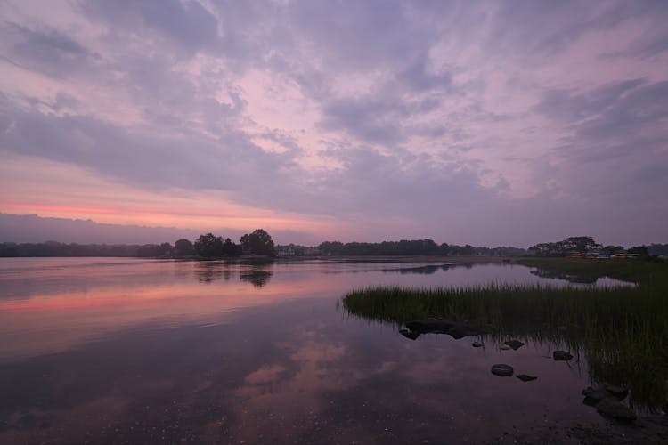 A Calm Body Of Water At Twilight