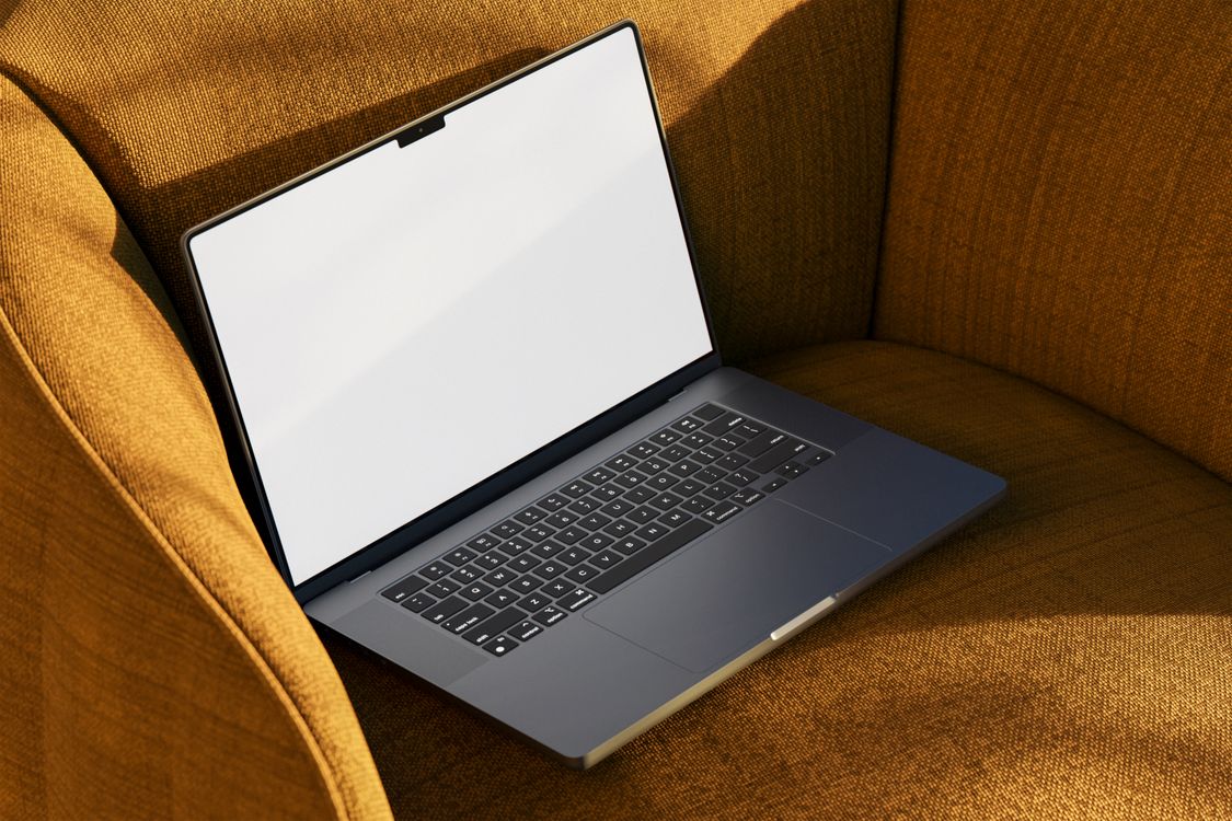 A Laptop on a Chair · Free Stock Photo