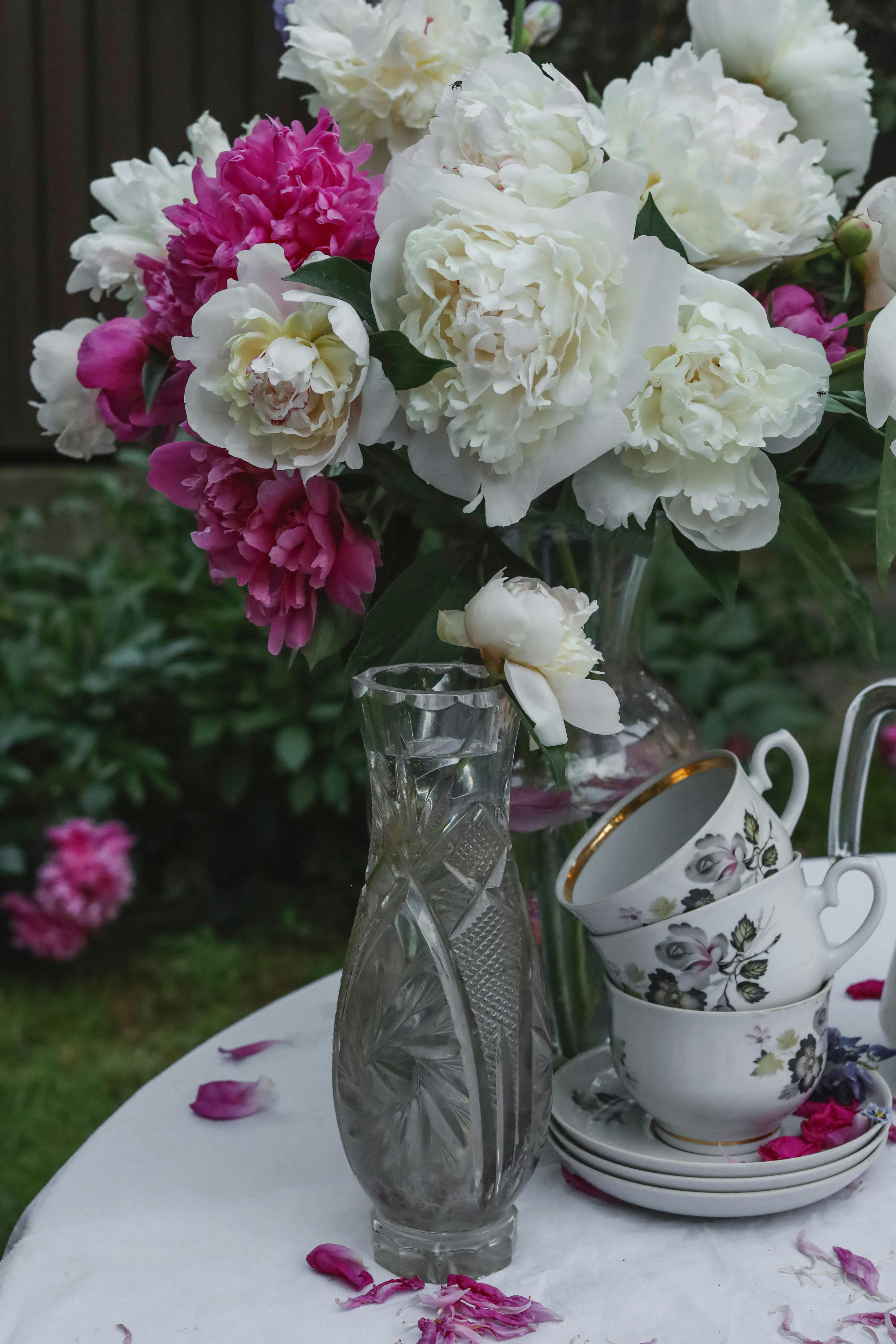 Flowers in a Vase and Tea Cups on a Table in the Garden · Free Stock Photo