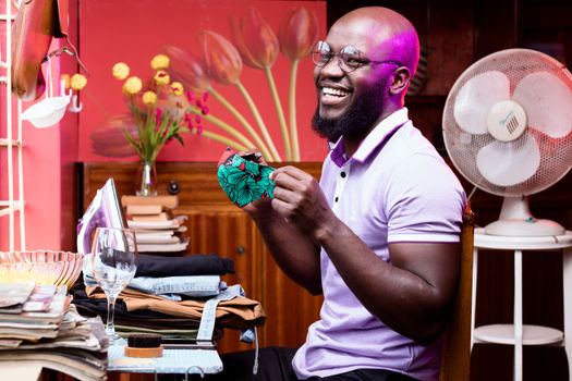 Smiling Man Holding a Face Mask