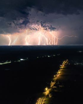 A captivating lightning storm illuminating the night sky over Licheń Stary, Poland.
