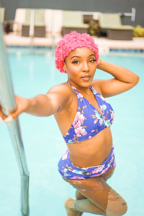 A Woman in a Blue Bikini Wearing a Pink Swim Cap