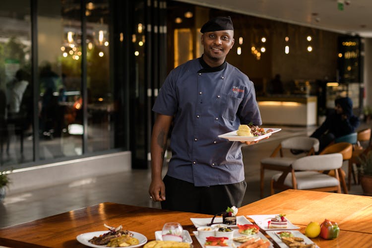 Smiling Waiter With Food