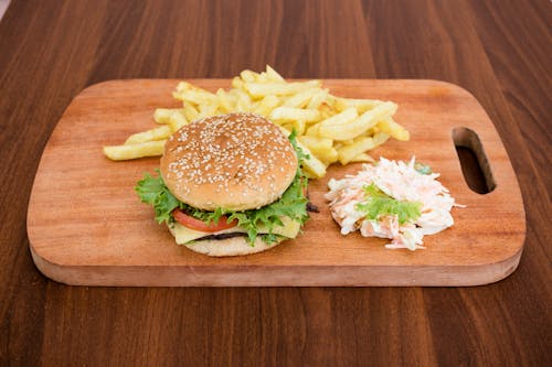 Burger and French Fries on Wooden Chopping Board