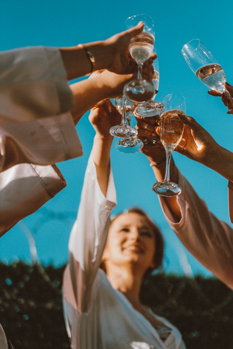 Women Raising Glasses Towards Sky