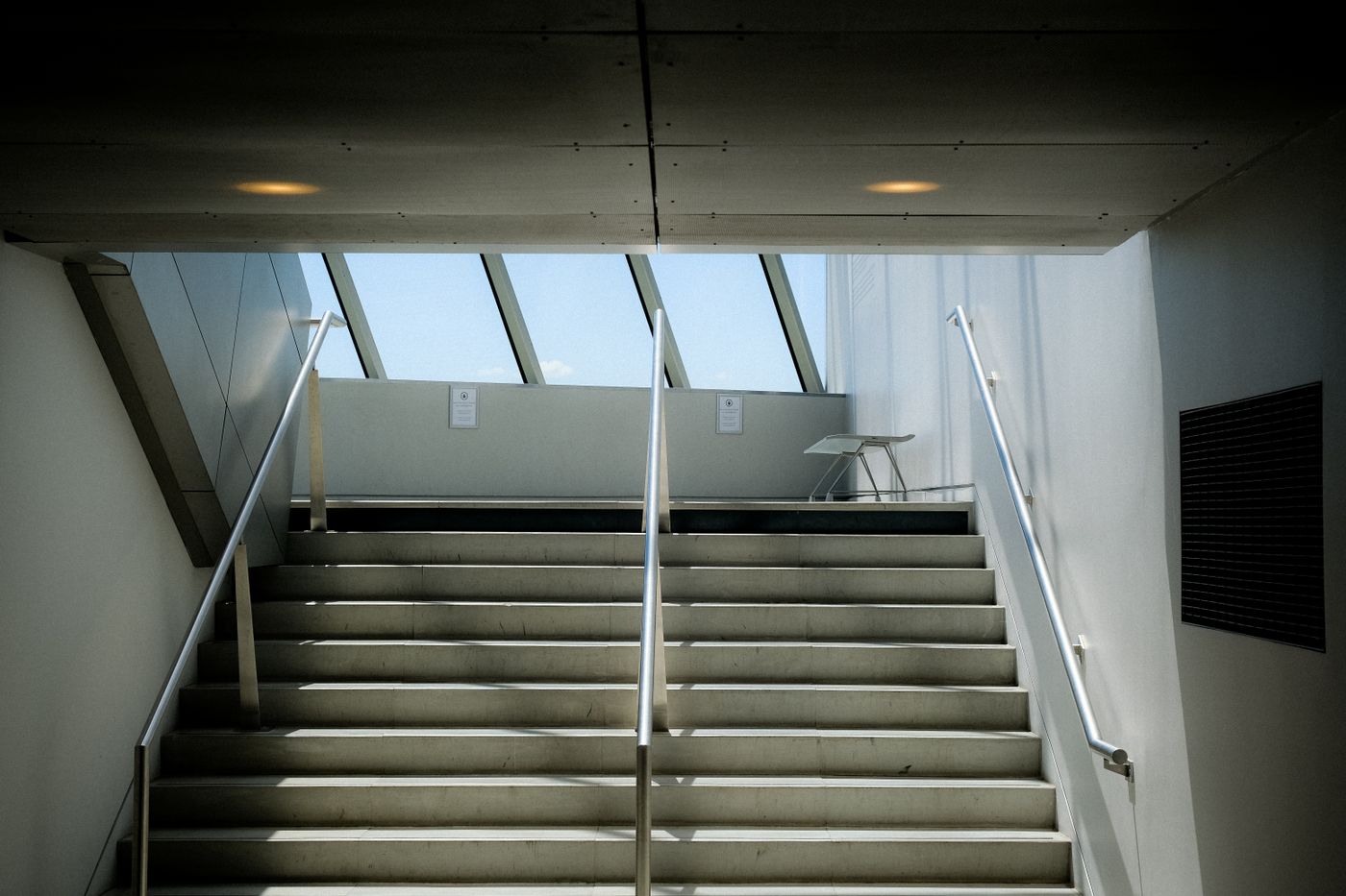 A concrete staircase lit from above